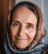 Portrait of middle eastern woman wearing had scarf and gently smiling